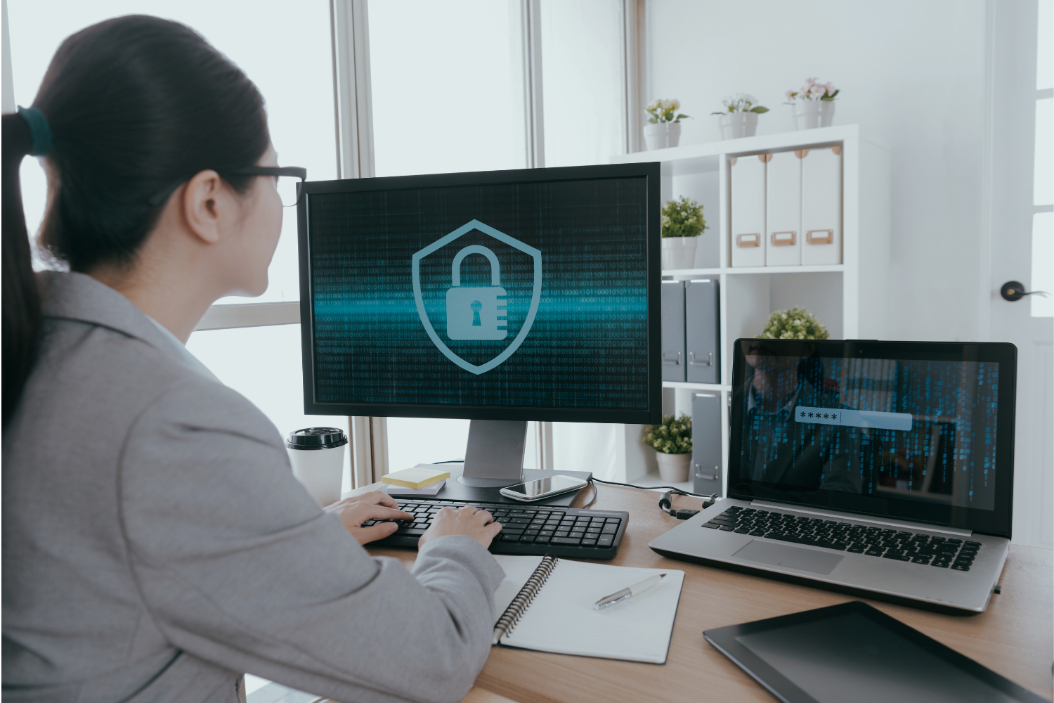 Woman on secure computer and laptop
